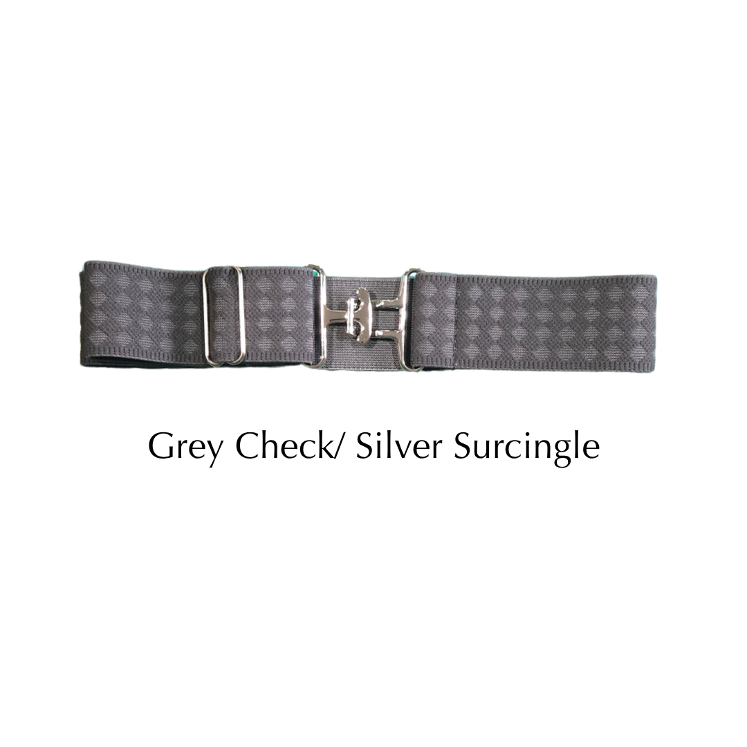 A grey checkered surcingle belt with a silver buckle, displayed horizontally on a white background with the text 'Grey Check/ Silver Surcingle' underneath.