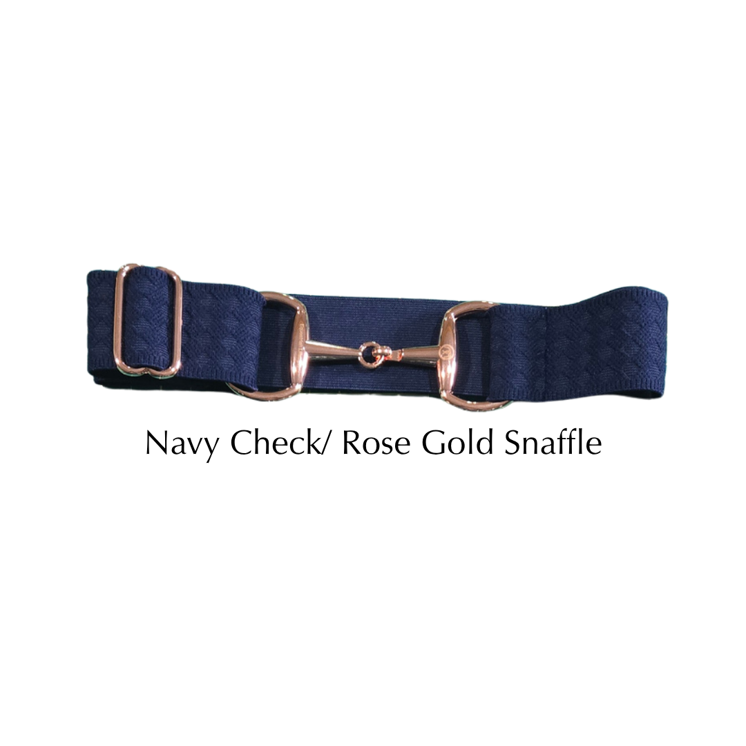 A navy blue checkered equestrian girth with a rose gold horse bit snaffle, displayed on a clean white background with the text 'Navy Check/ Rose Gold Snaffle' underneath.