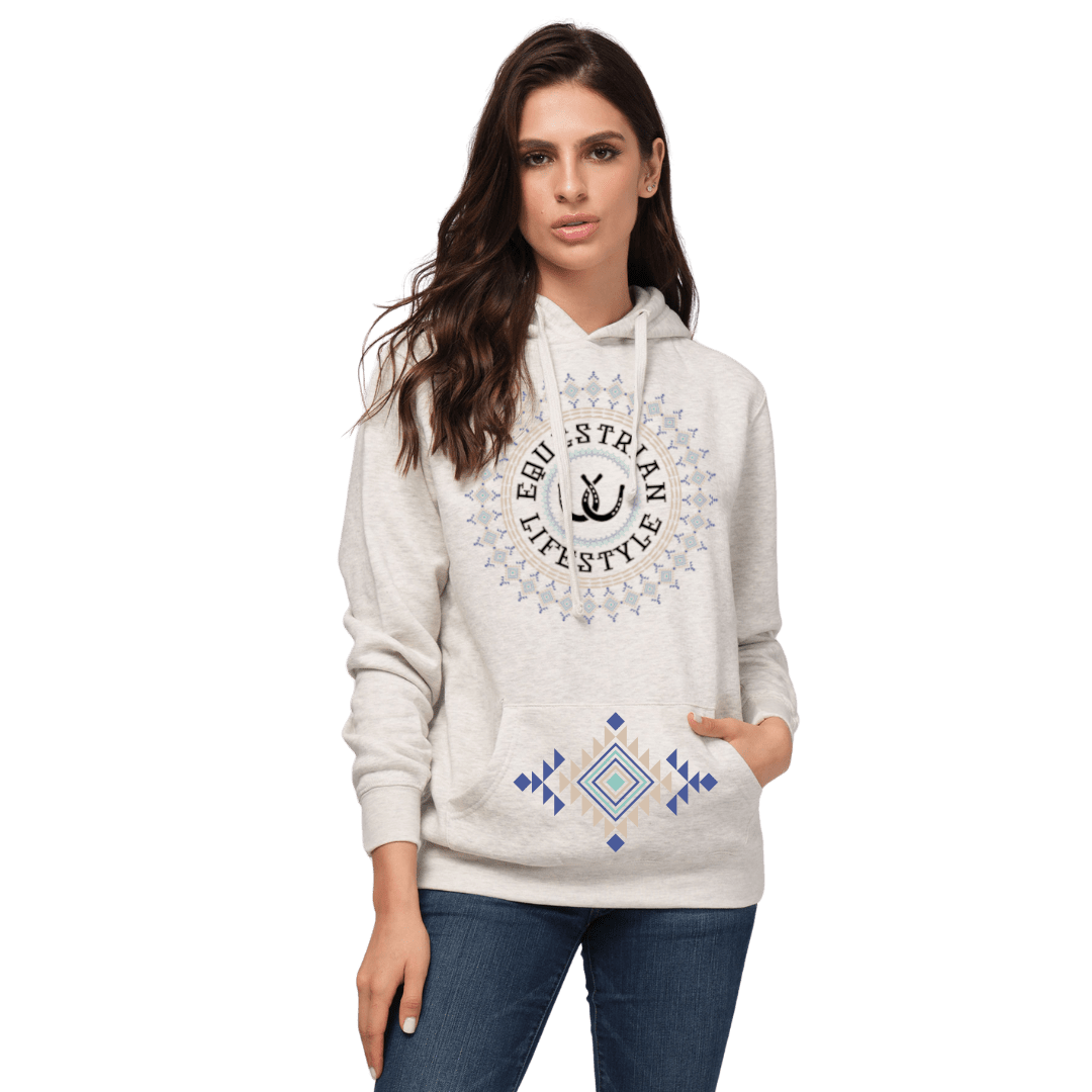 A woman modeling a light heather gray hoodie with a circular 'equestrian Lifestyle' graphic on the chest and a blue and yellow geometric pattern on the front pocket, paired with blue jeans against a plain white background.