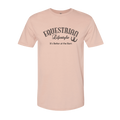 A light peach-pink short-sleeve crewneck t-shirt with a black graphic print on the chest reading 'EQUESTRIAN Lifestyle It's Better at the Barn' with a horseshoe symbol, shown on a plain white background.