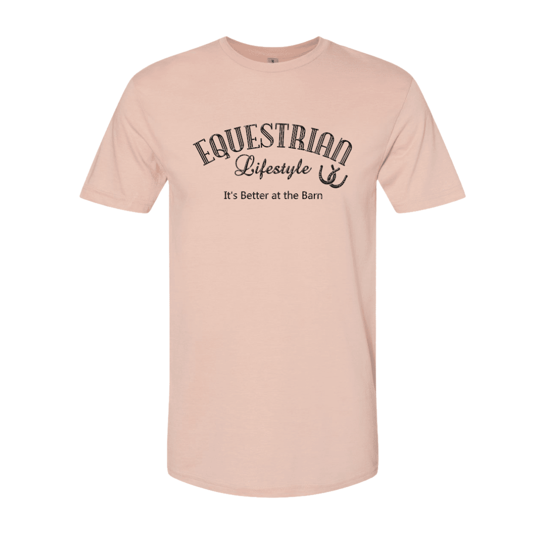A light peach-pink short-sleeve crewneck t-shirt with a black graphic print on the chest reading 'EQUESTRIAN Lifestyle It's Better at the Barn' with a horseshoe symbol, shown on a plain white background.