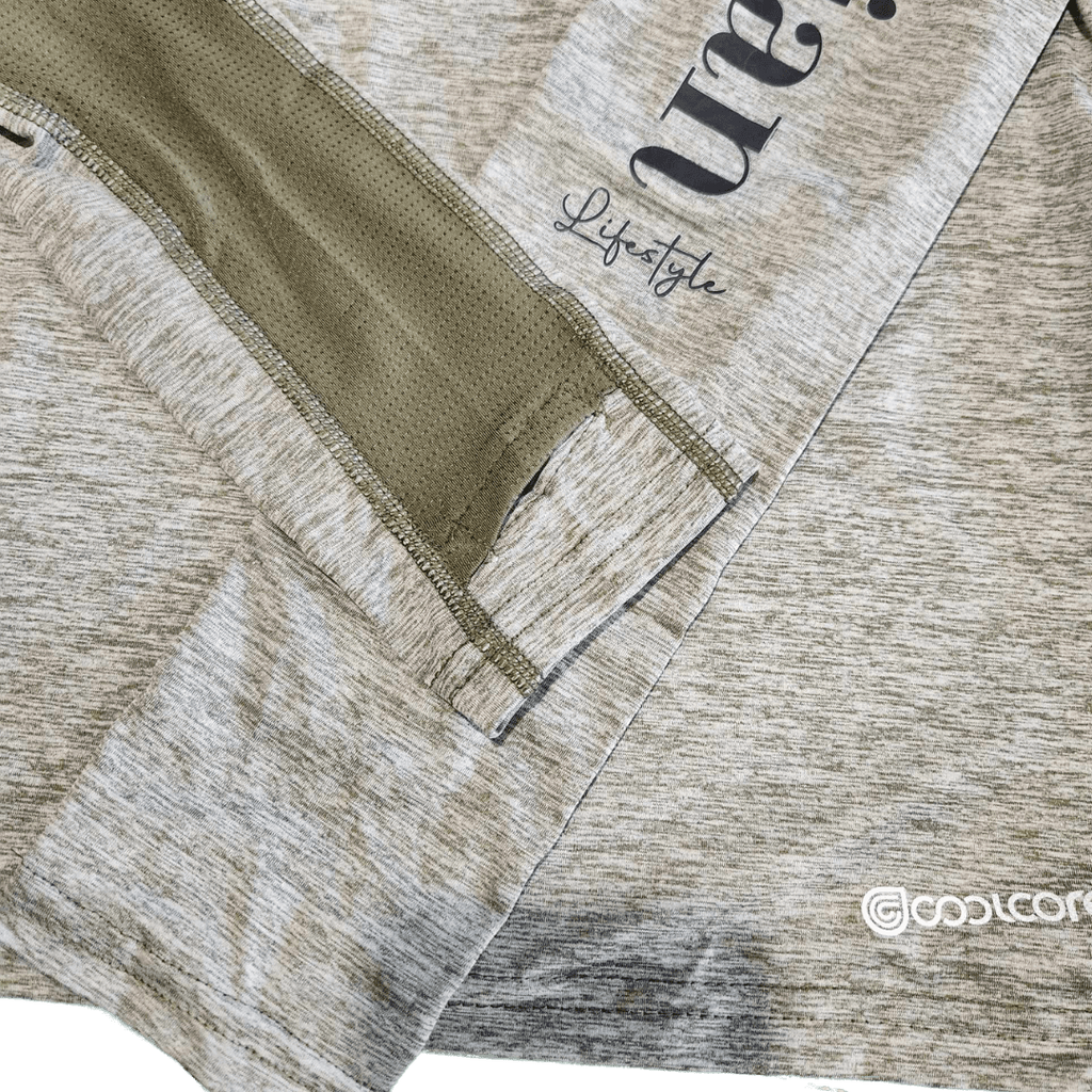 Close-up of a heathered light brown athletic top with an olive green mesh and partial black text reading 'Lifestyle' and a visible Coolcore logo.
