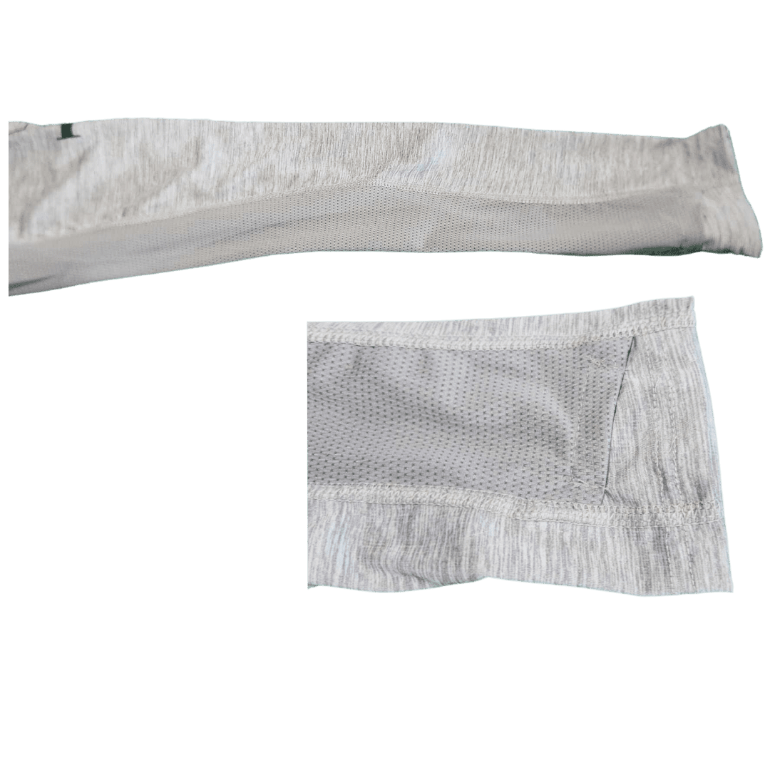 A close-up of a light gray athletic sleeve or arm warmer showing both the ribbed knit cuff and the textured mesh fabric, isolated on a white background.