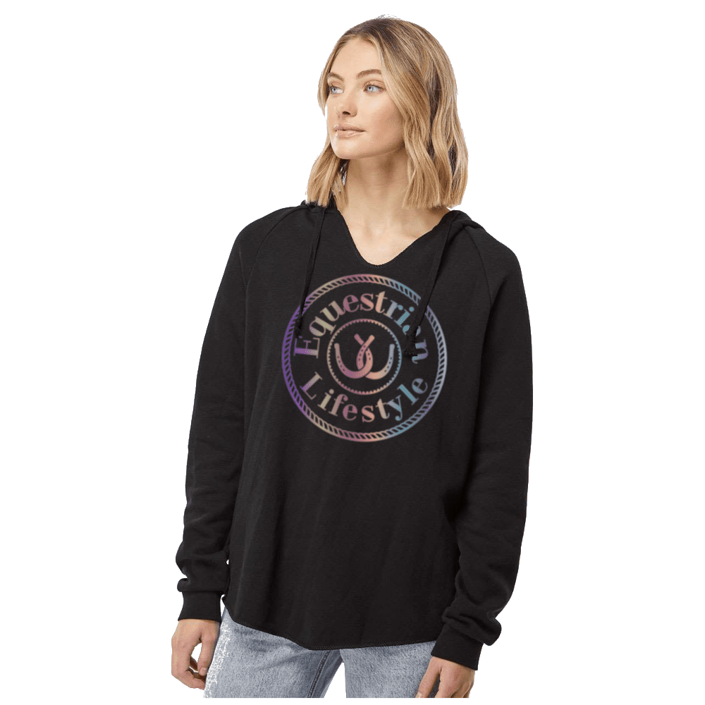 A woman wearing a black long-sleeve hoodie with a large circular 'Equestrian Lifestyle' graphic on the chest, featuring a rainbow gradient. She is posing against a solid white background.