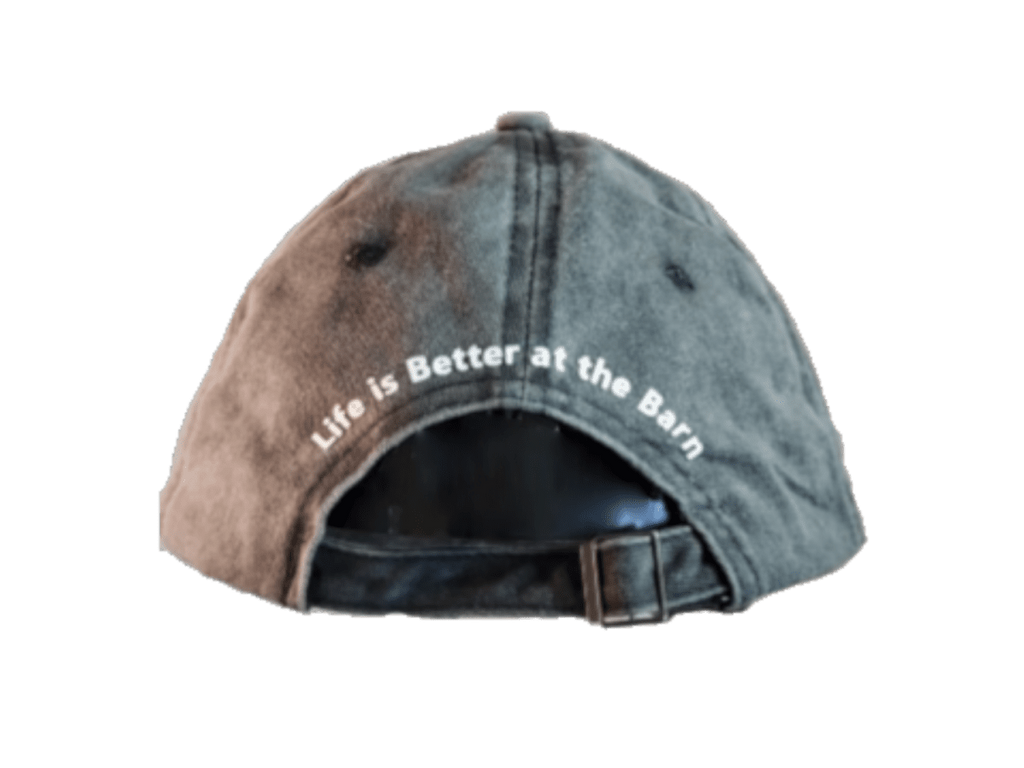 A washed, distressed baseball cap shown from the back, featuring the white embroidered text 'Life is Better at the Barn' on the crown and an adjustable strap closure.