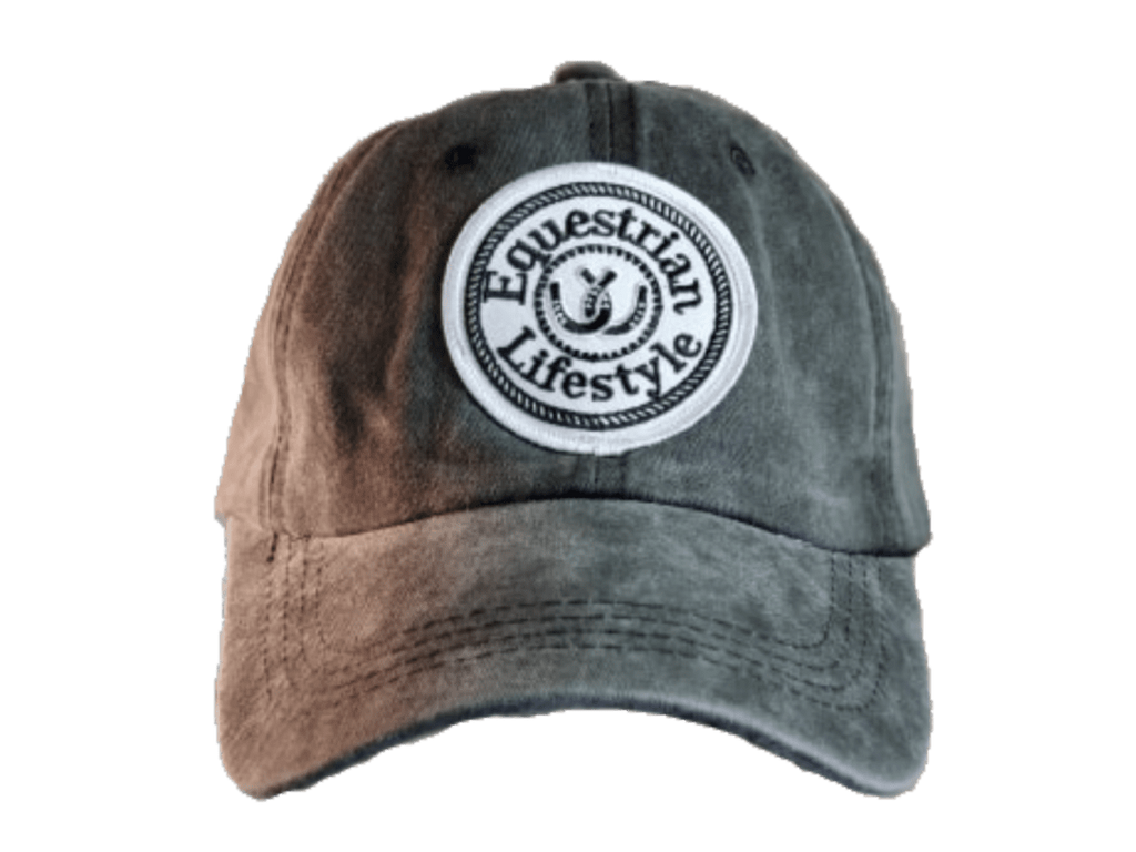 A distressed baseball cap with a brown-to-gray gradient wash, featuring a circular white embroidered patch on the front that reads 'Equestrian Lifestyle'.