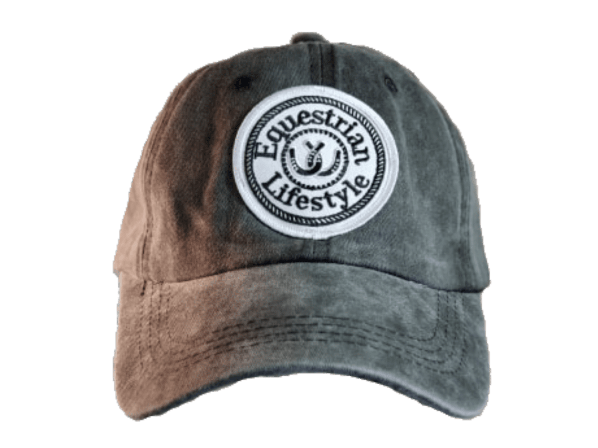 A distressed baseball cap with a brown-to-gray gradient wash, featuring a circular white embroidered patch on the front that reads 'Equestrian Lifestyle'.