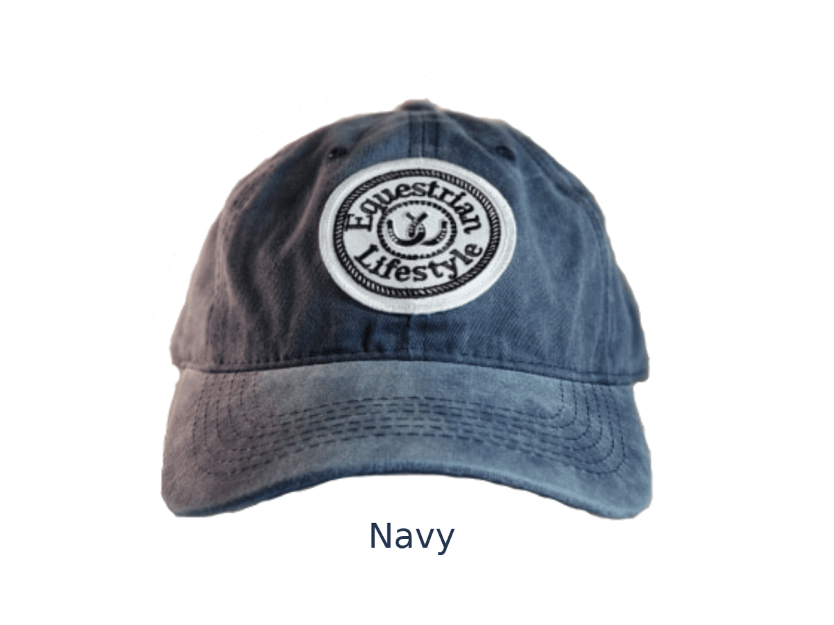 A navy blue washed cotton baseball cap with a circular embroidered patch on the front that reads 'Equestrian Lifestyle' in black text on a white background. The word 'Navy' is printed below the hat on a plain white background.