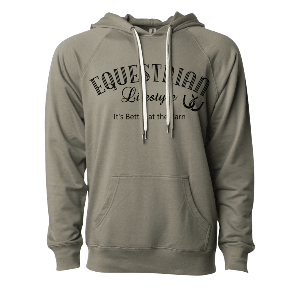 A sage green pullover hoodie with a black graphic print on the chest reading 'EQUESTRIAN Lifestyle' and 'It's Better at the Barn' with a horsehoer symbol. The hoodie features white drawstrings and a front kangaroo pocket, shown against a plain white background.