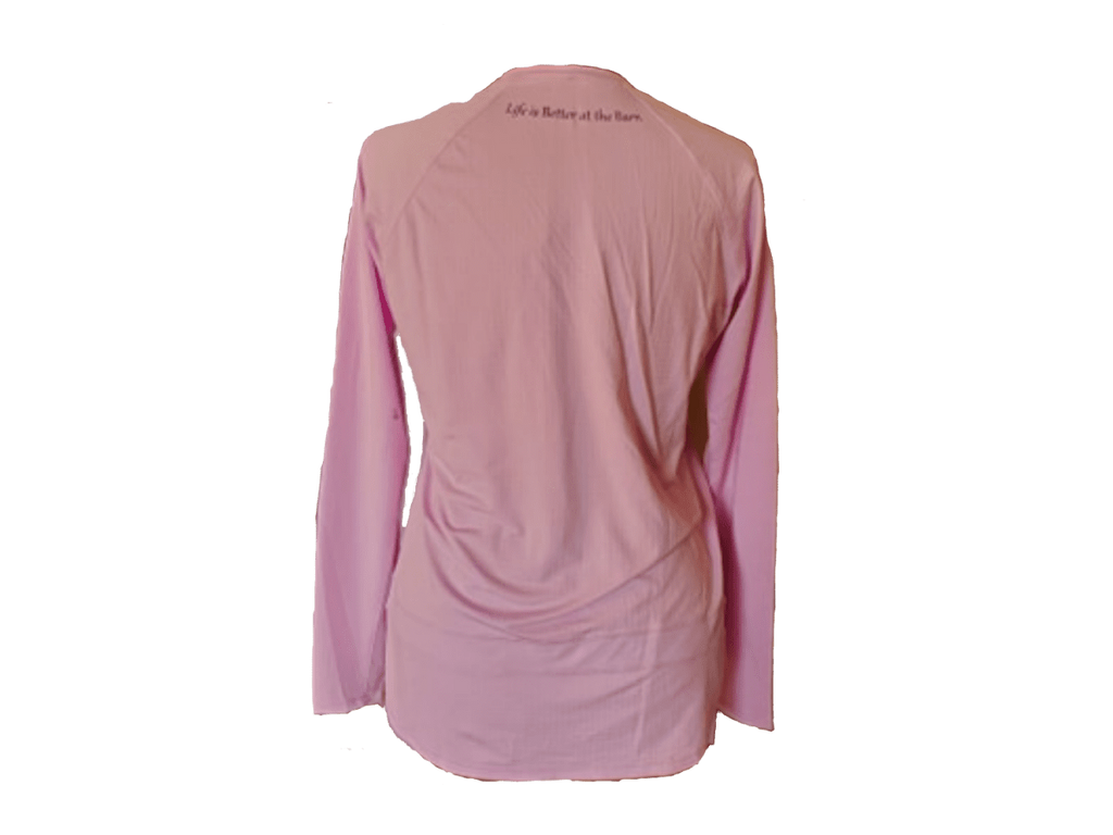 A pink long-sleeve athletic top shown from the back, featuring the printed text 'Life is Better at the barn' across the upper neck, displayed against a solid white background.