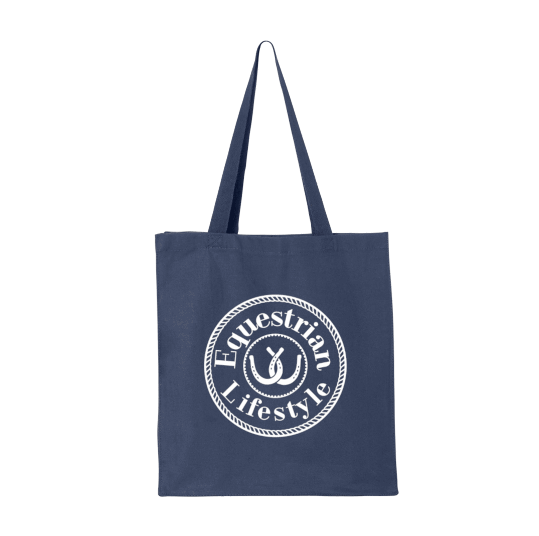 A navy blue canvas tote bag with two shoulder straps, featuring a white circular graphic on the front that reads 'Equestrian Lifestyle' with an horseshoe symbol inside.