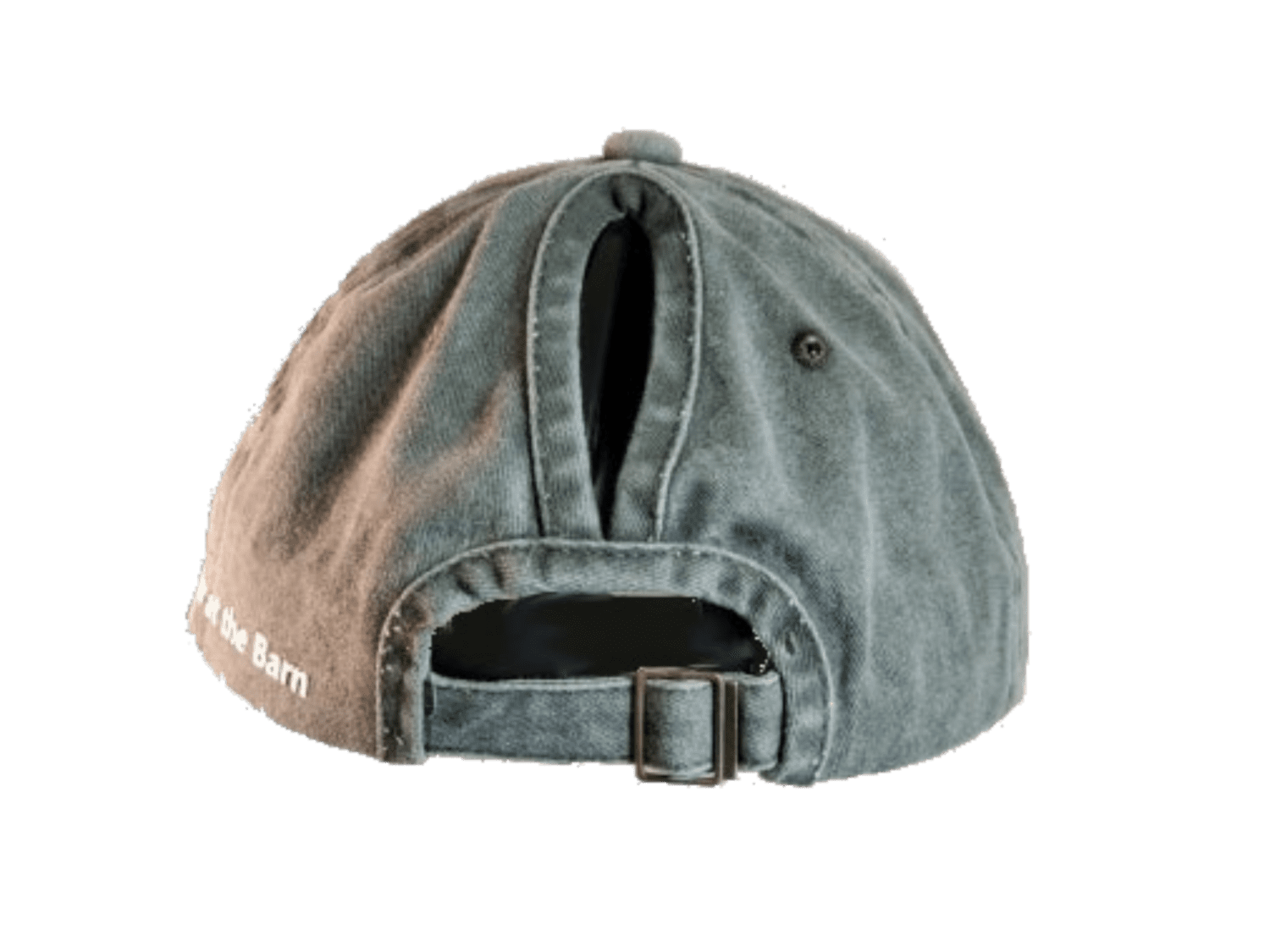 A washed gray-green baseball cap shown from the back, featuring a fabric strap with a metal buckle and white embroidered text reading 'at the Barn' on the side.