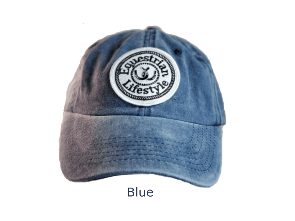 A blue washed cotton baseball cap with a circular white and black embroidered patch reading 'Equestrian Lifestyle' on the front, shown against a plain white background with the word 'Blue' below.