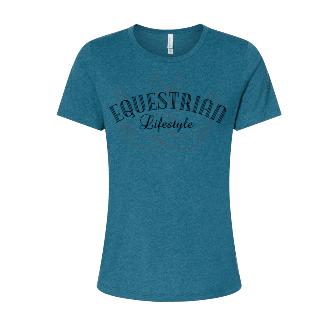 A women's short-sleeve crewneck t-shirt in heathered teal blue, featuring a dark navy graphic on the chest that reads 'EQUESTRIAN Lifestyle' with a horseshoe outline.