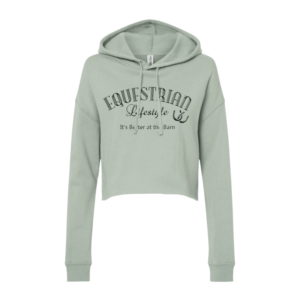 A sage green cropped hoodie sweatshirt with 'EQUESTRIAN Lifestyle' and 'It's Better at th Barn' printed in black on the front, displayed on a clean white background.