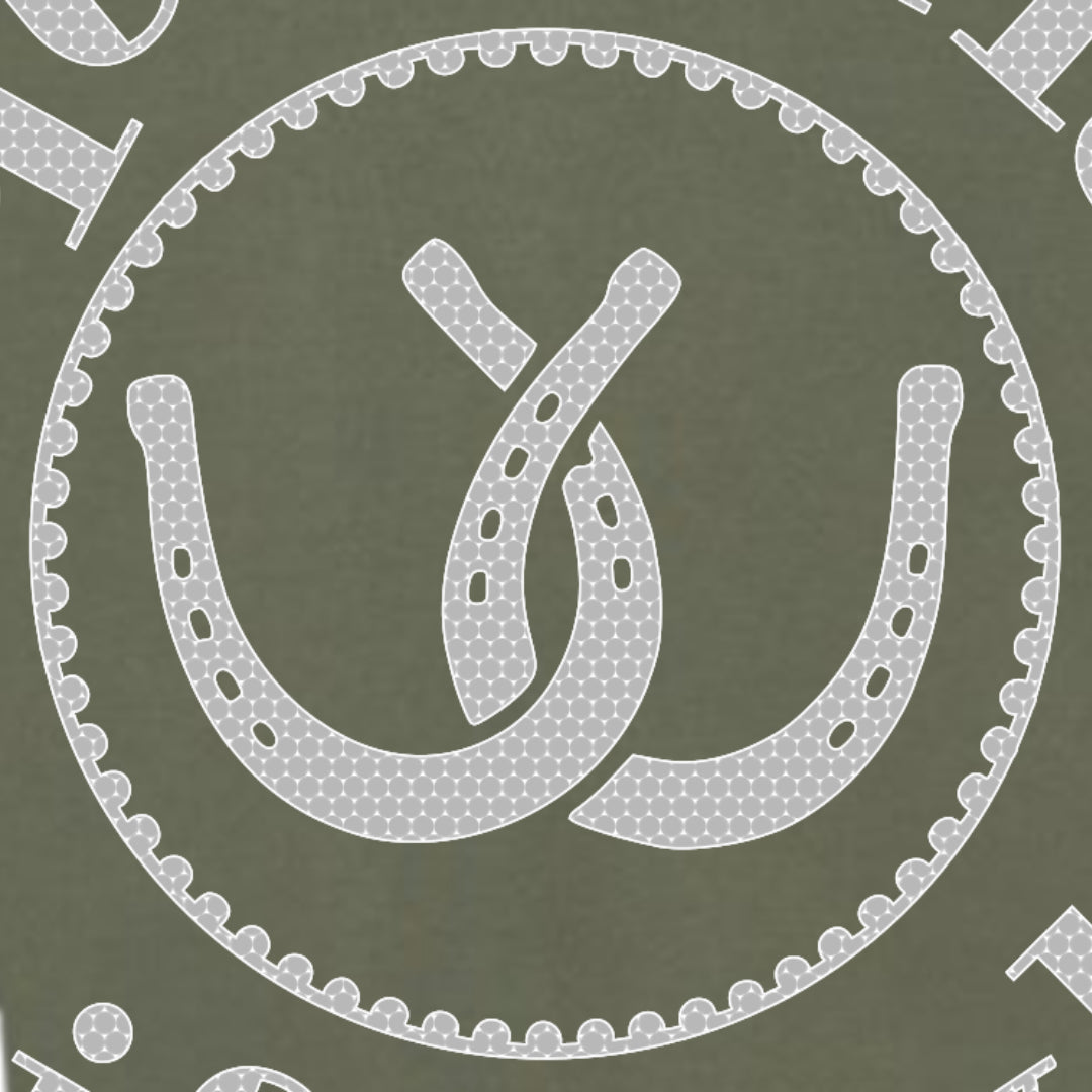 A close-up of the front design pattern featuring a white horseshoe and interlocking loops motif inside a scalloped circular border on an olive green background.