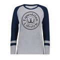 A women's long-sleeve raglan t-shirt in heather gray and navy blue, featuring a black circular 'Equestrian Lifestyle' graphic on the chest with a horseshoe