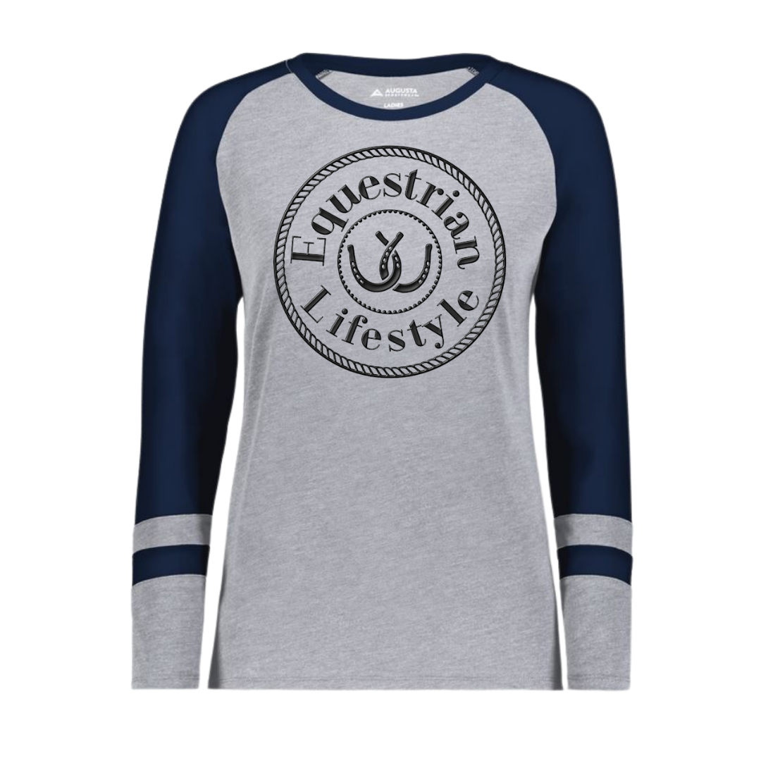 A women's long-sleeve raglan t-shirt in heather gray and navy blue, featuring a black circular 'Equestrian Lifestyle' graphic on the chest with a horseshoe