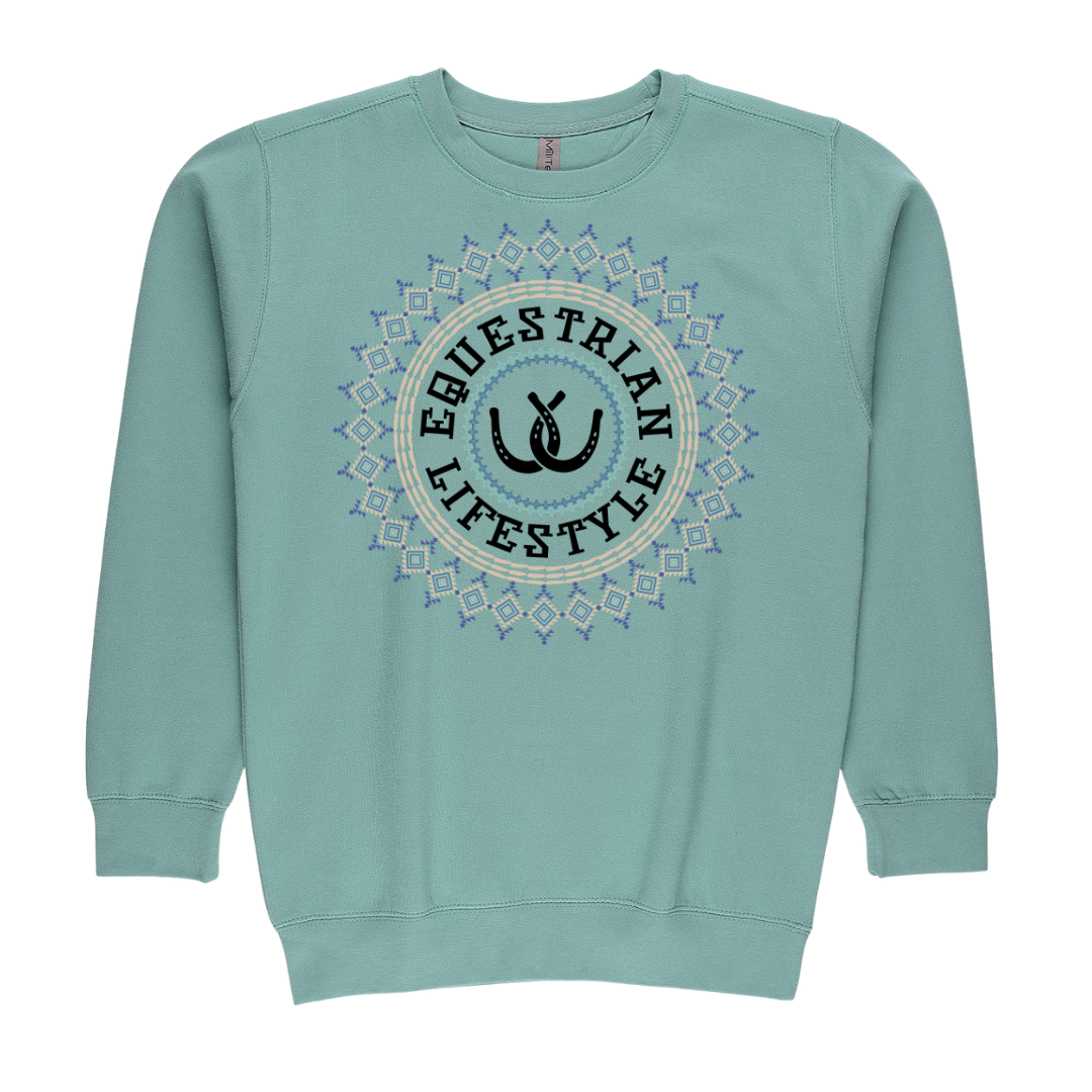 A light teal crewneck sweatshirt featuring a circular graphic on the chest with the words 'EQUESTRIAN LIFESTYLE' and a horse silhouette, surrounded by a geometric aztec  pattern.