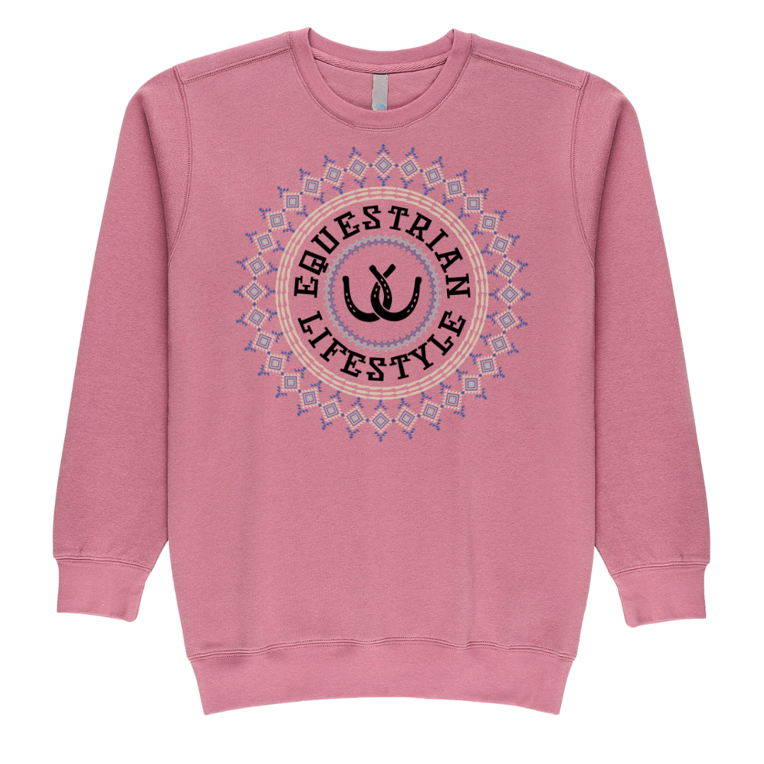 A pink crewneck sweatshirt featuring a circular graphic on the chest with the words 'EQUESTRIAN LIFESTYLE' in black around a central black horse shoe silhouette, surrounded by a pink and blue geometric Aztec pattern.