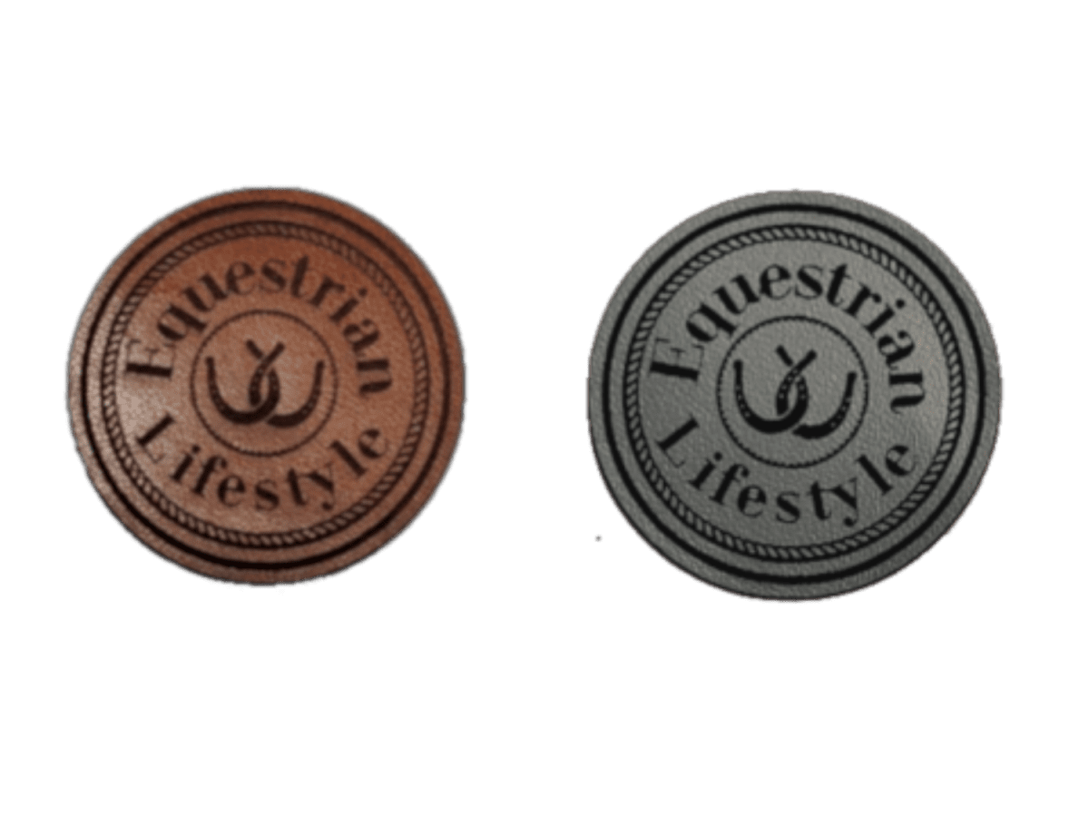 Two round leatherette patches with the text 'Equestrian Lifestyle' and a central horse-and-bit motif, shown side by side on a plain white background. One patch is brown and the other is dark gray.