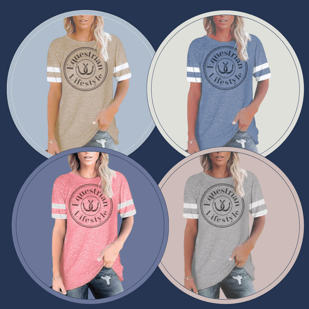 Four women modeling the same graphic T-shirt in different colorways: beige, heather blue, heather coral pink, and heather gray. Each shirt has white sleeve stripes and a large circular 'EquineSpirit Lifestyle' logo with an anchor graphic on the chest, shown on a dark blue background with circular cutouts.