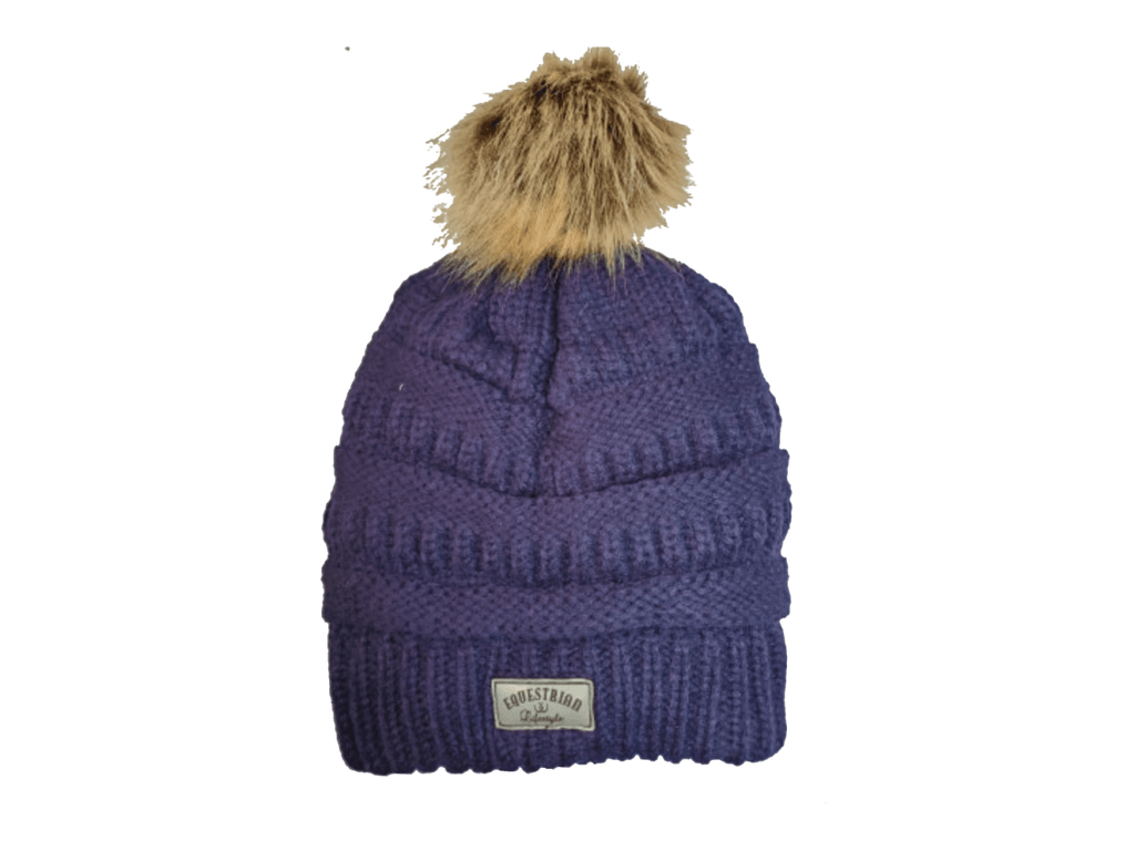 A purple ribbed knit beanie hat with a brown faux fur pom-pom on top and a small 'equestrian lifestyle' brand patch on the front cuff, shown against a plain white background.