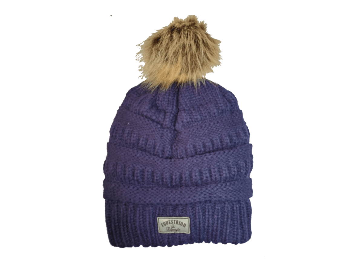 A purple ribbed knit beanie hat with a brown faux fur pom-pom on top and a small 'equestrian lifestyle' brand patch on the front cuff, shown against a plain white background.