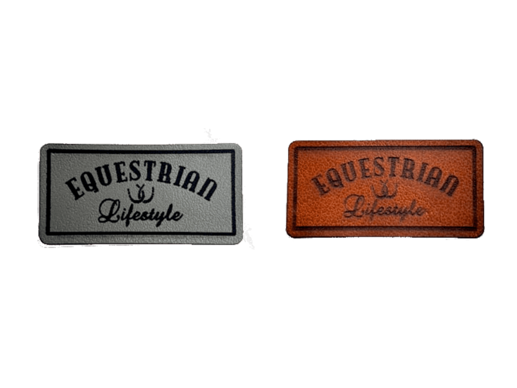 Two rectangular embroidered patches with the words 'EQUESTRIAN Lifestyle' and a small horseshoe symbol, shown side by side on a plain white background. One patch is gray with black , and the other is brown with black.