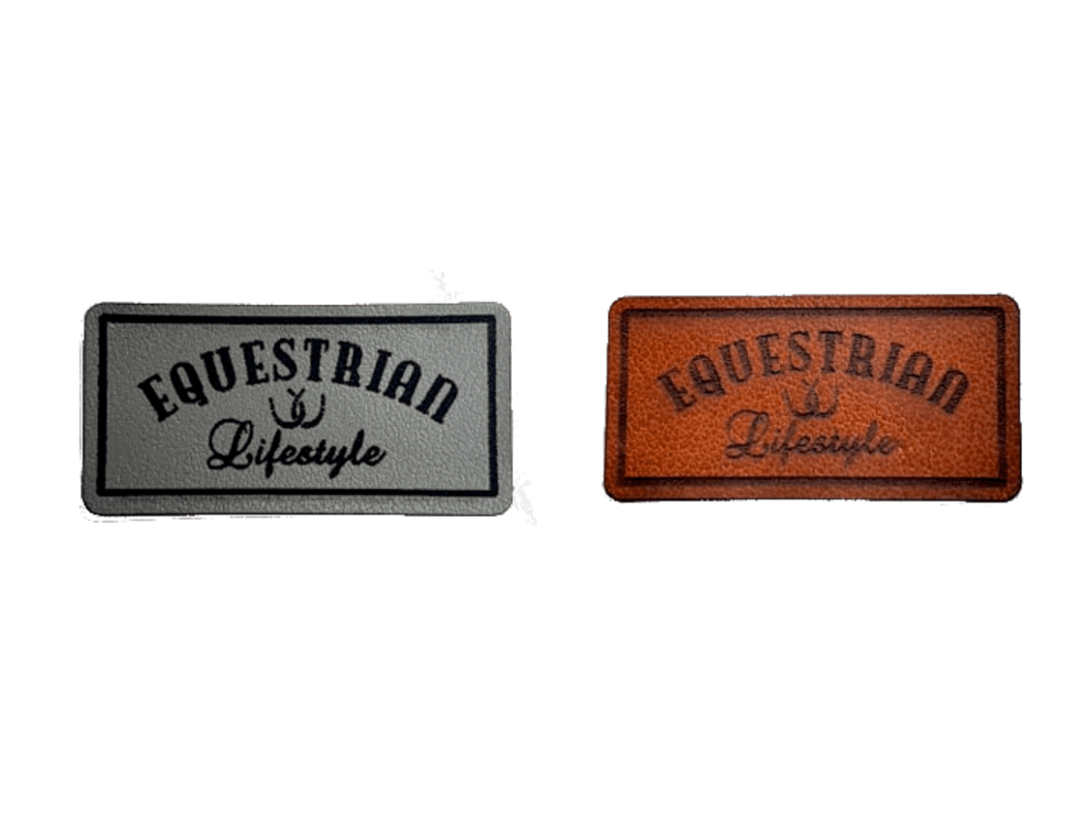 Two rectangular embroidered patches with the words 'EQUESTRIAN Lifestyle' and a small horseshoe symbol, shown side by side on a plain white background. One patch is gray with black , and the other is brown with black.