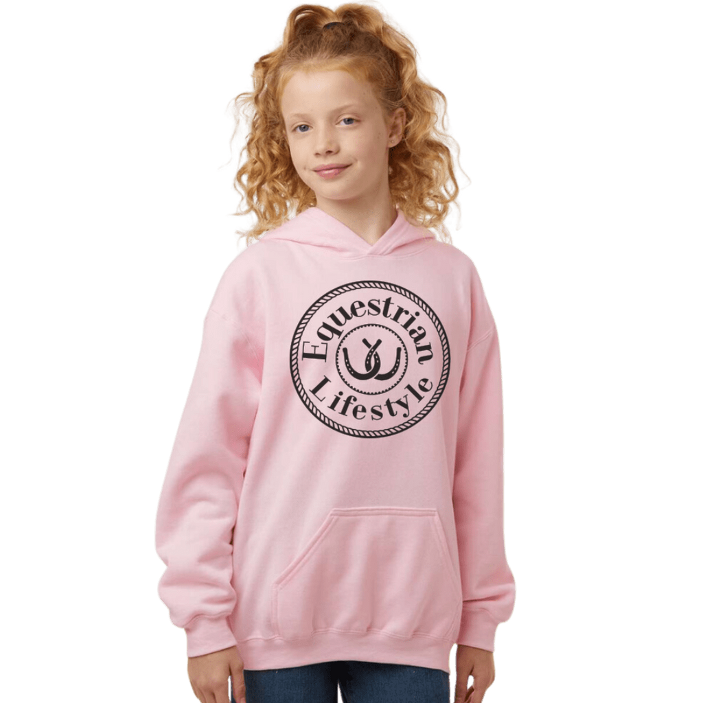 A young girl with curly red hair wearing a light pink pullover hoodie with a black circular 'Equestrian Lifestyle' logo on the chest, set against a plain white background.
