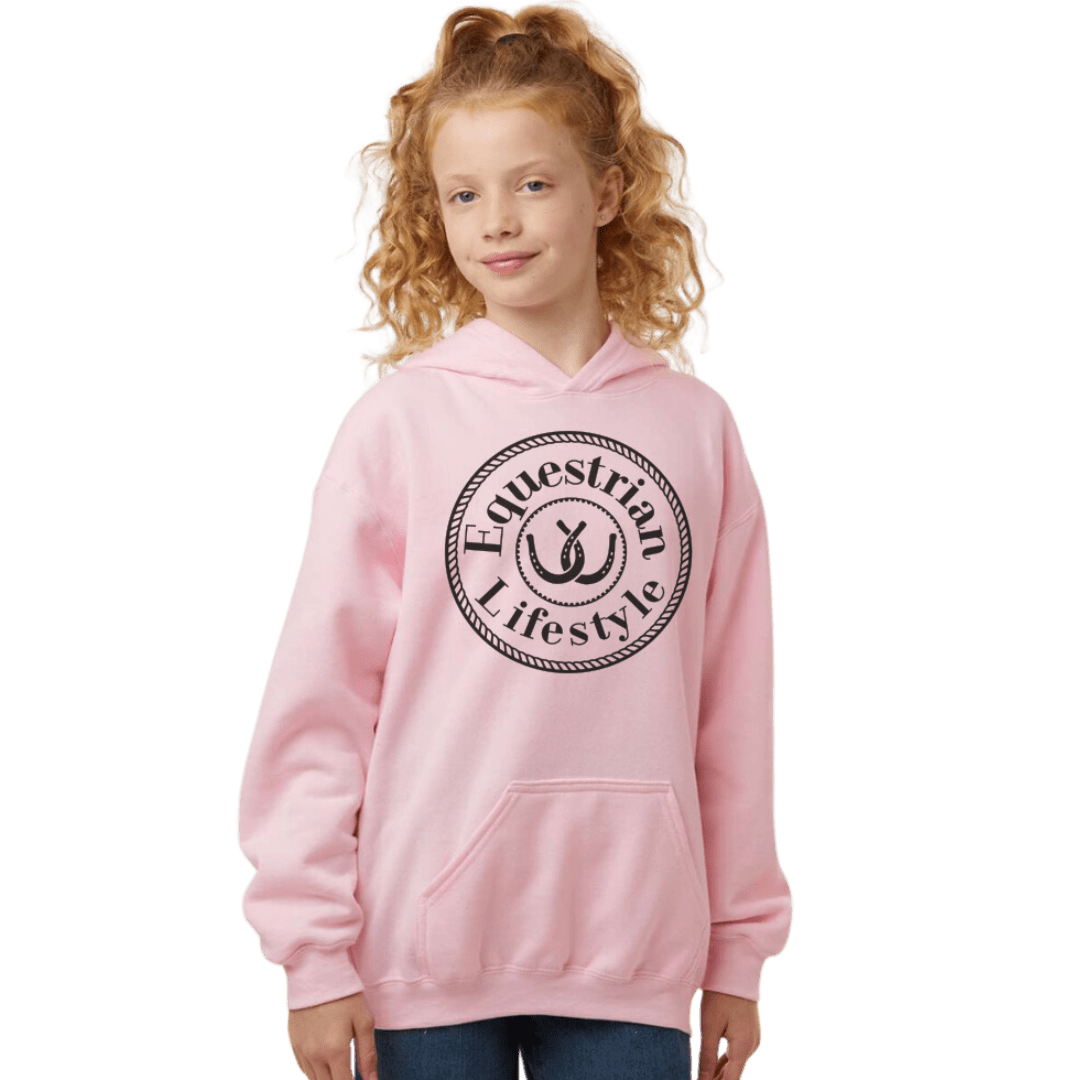 A young girl with curly red hair wearing a light pink pullover hoodie with a black circular 'Equestrian Lifestyle' logo on the chest, set against a plain white background.